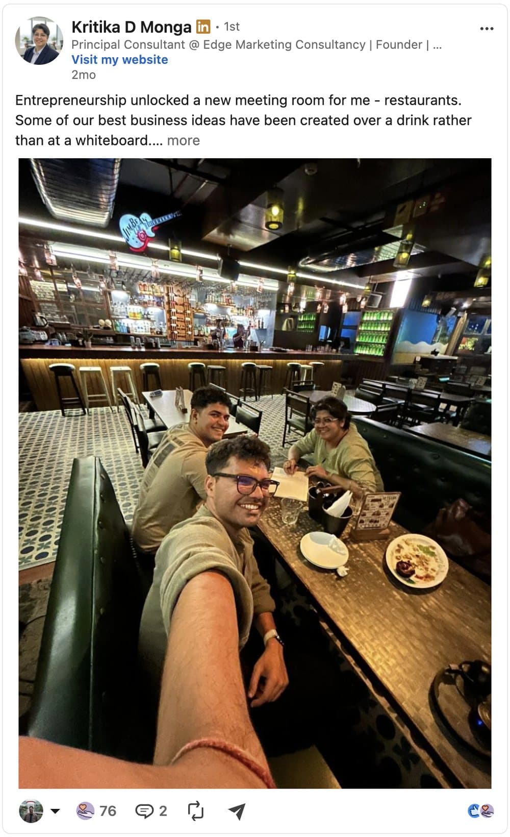 LinkedIn post by Kritika D Monga about business ideas created over a drink rather than at a whiteboard.